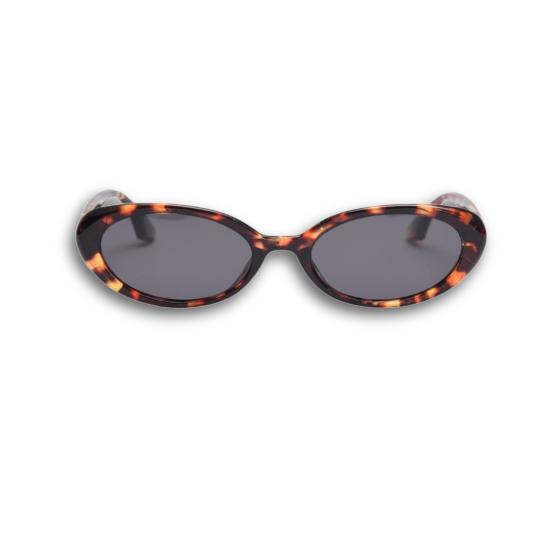 Pink Baby Kyra tort polarized sunglasses with round frames and tinted lenses, stylish eyewear for sun protection.