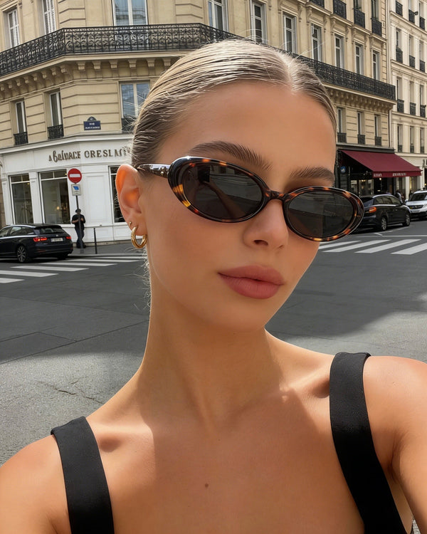 Pink Baby The Kyra tort sunglasses with rounded frames and dark lenses, stylish and protective for sunny days.