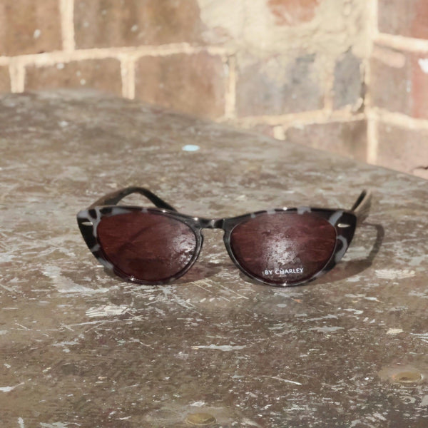 Pink Baby The Bailey tort sunglasses with rounded brown frames and dark tinted lenses, stylish eyewear for sunny days.