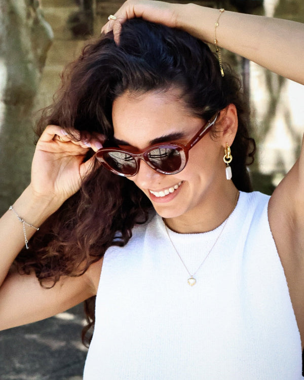 Pink Baby The Freesia red cateye polarized sunglasses with stylish frame and tinted lenses.