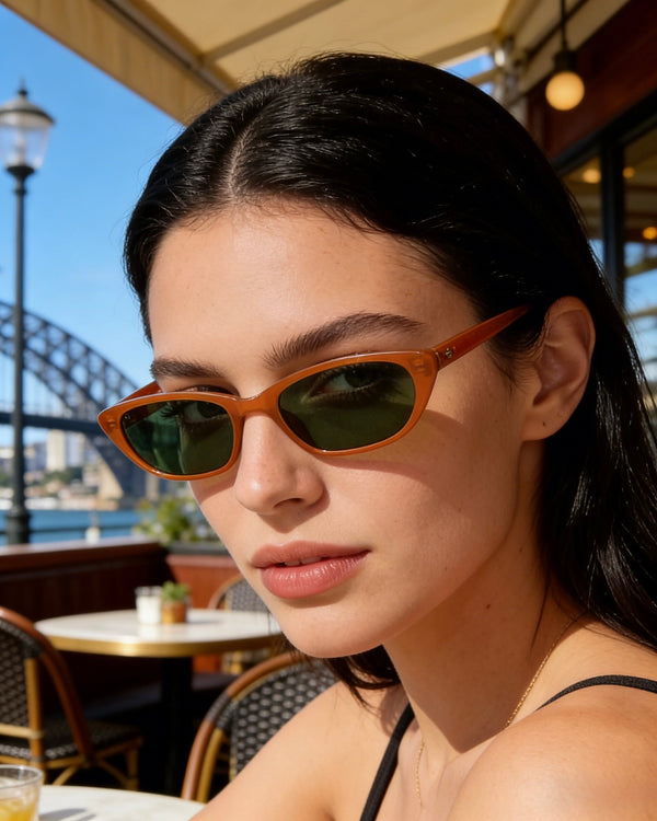 Pink Baby The Indie pumpkin-shaped sunglasses with orange tinted lenses and pink frames, stylish and fun for sunny days.