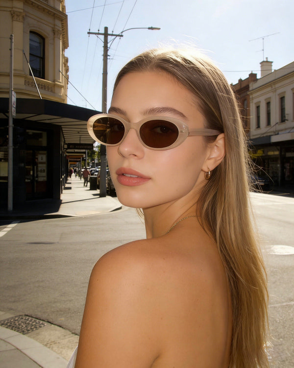 Pink Baby The Kiara cinnamon sunglasses with round frames and tinted lenses, stylish and fashionable eyewear for women.