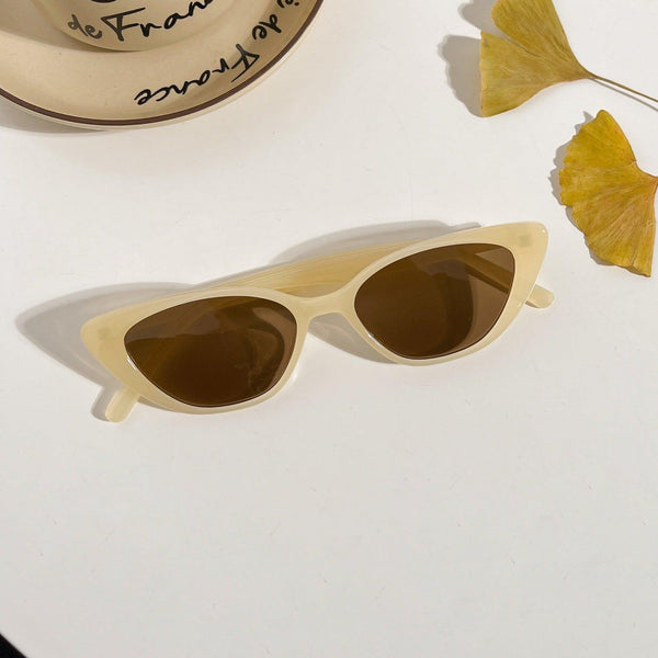 Pink Baby Juno cat-eye sunglasses in lemon yellow with tinted lenses, stylish and fashionable accessory for sunny days.