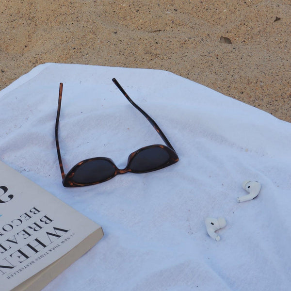 Pink Baby Juno sunglasses with tortoiseshell frames and polarized lenses, stylish and UV-protective for sunny days.
