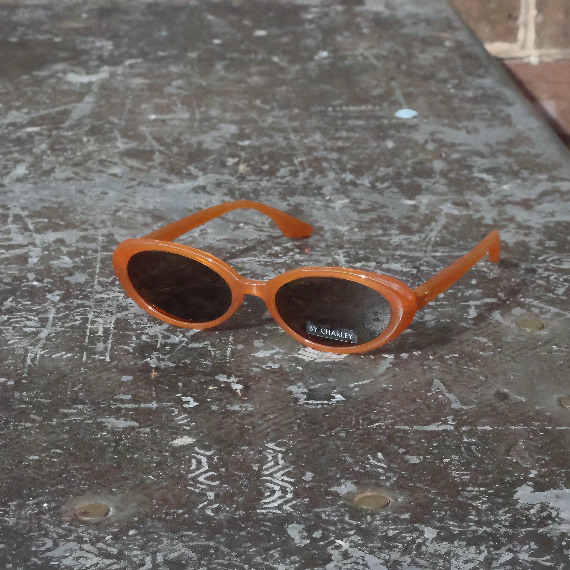 Pink Baby The Kyra pumpkin polarized sunglasses with orange-tinted lenses and stylish frame, perfect for sunny days.