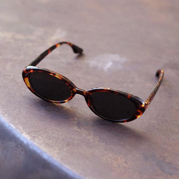Pink Baby The Kyra tortoise shell polarized sunglasses with rounded frames and dark tinted lenses.