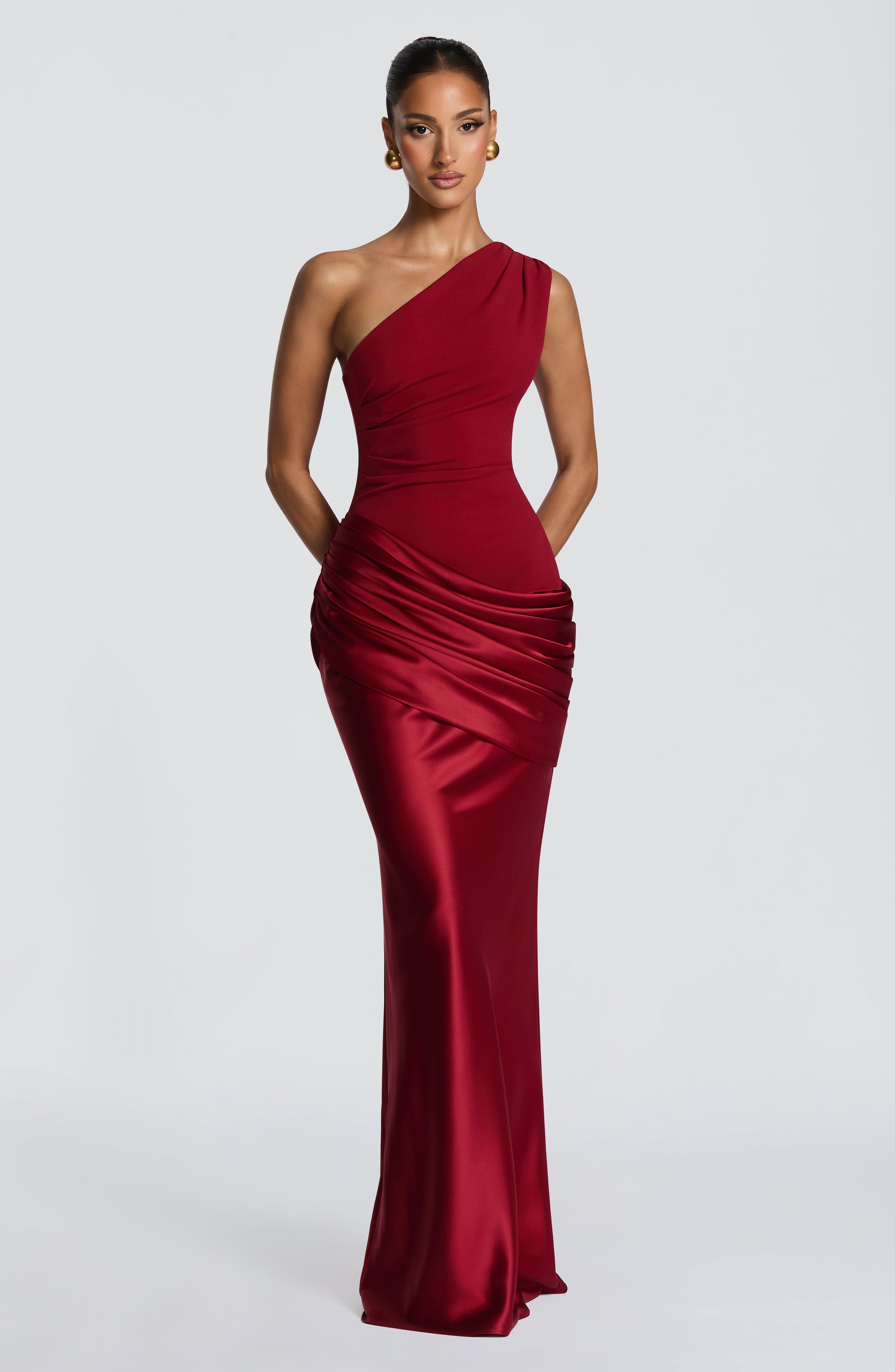 Deep red Sadona Maxi Dress by Pink Baby, flowing fabric, sleeveless design, and elegant silhouette showcased in the image.