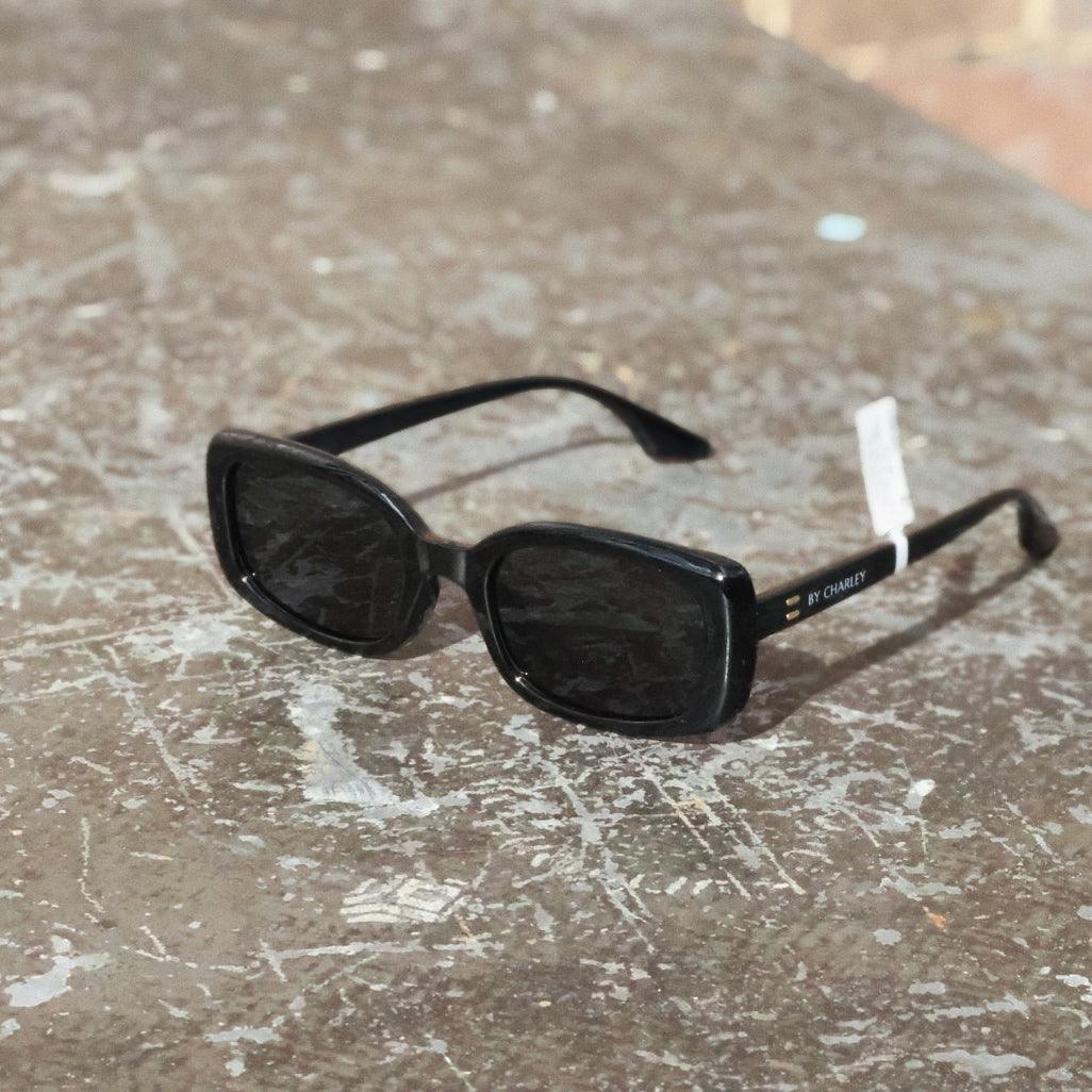 Pink Baby The Fern black sunglasses with rounded frames and tinted lenses, stylish eyewear for sun protection.