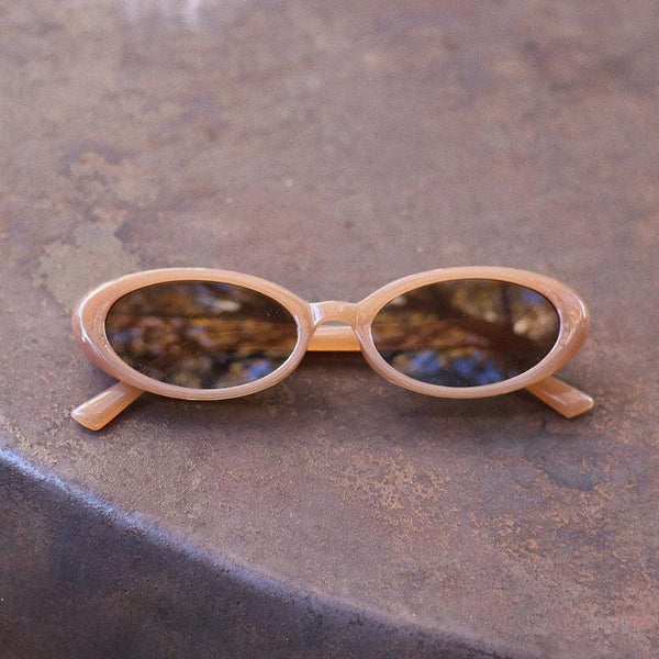 Pink Baby The Kyra cinnamon sunglasses with rounded frames and tinted lenses, stylish accessories for sunny days.