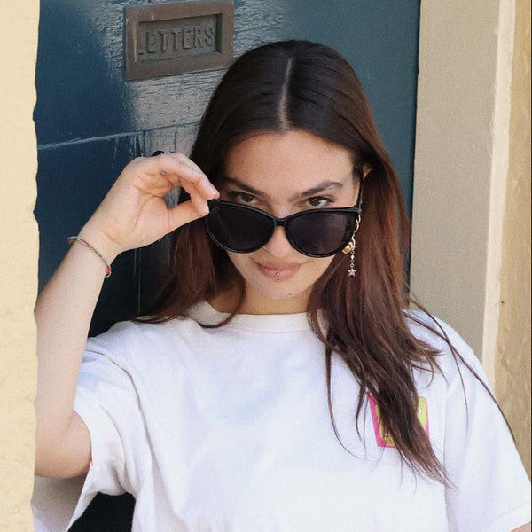Pink Baby Yule black sunglasses with sleek, rounded frames and tinted lenses for stylish sun protection.